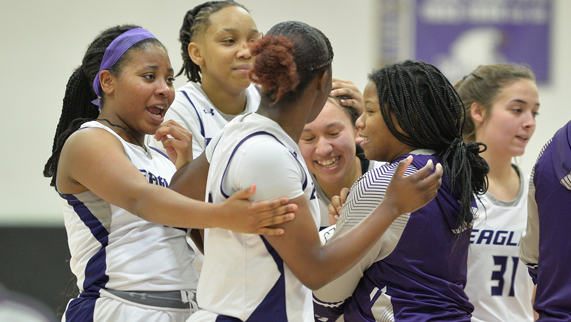 Teammates celebrate with Lili Garcia after hitting a clutch three-pointer late in the game.
